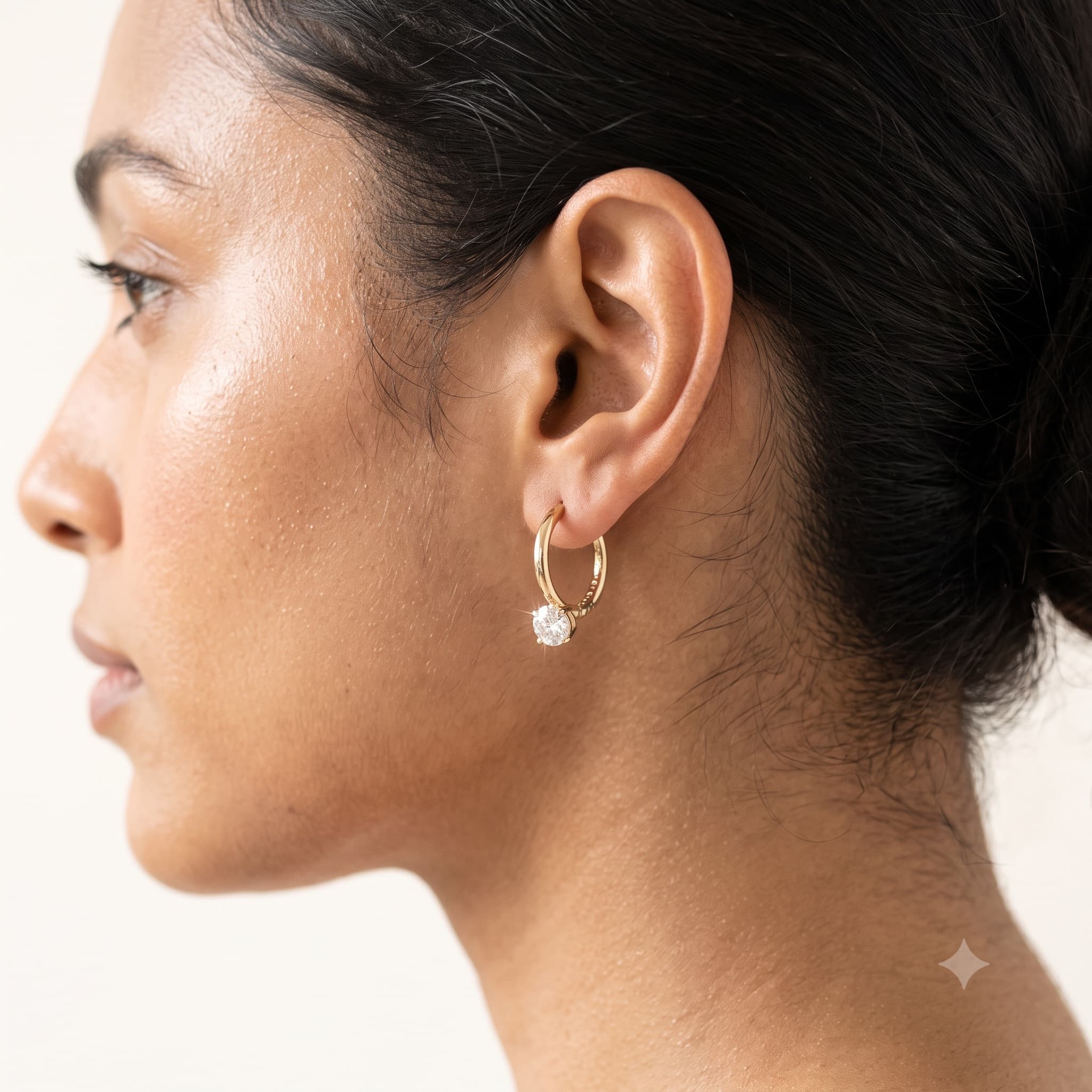 Model wearing gold hoop earrings
