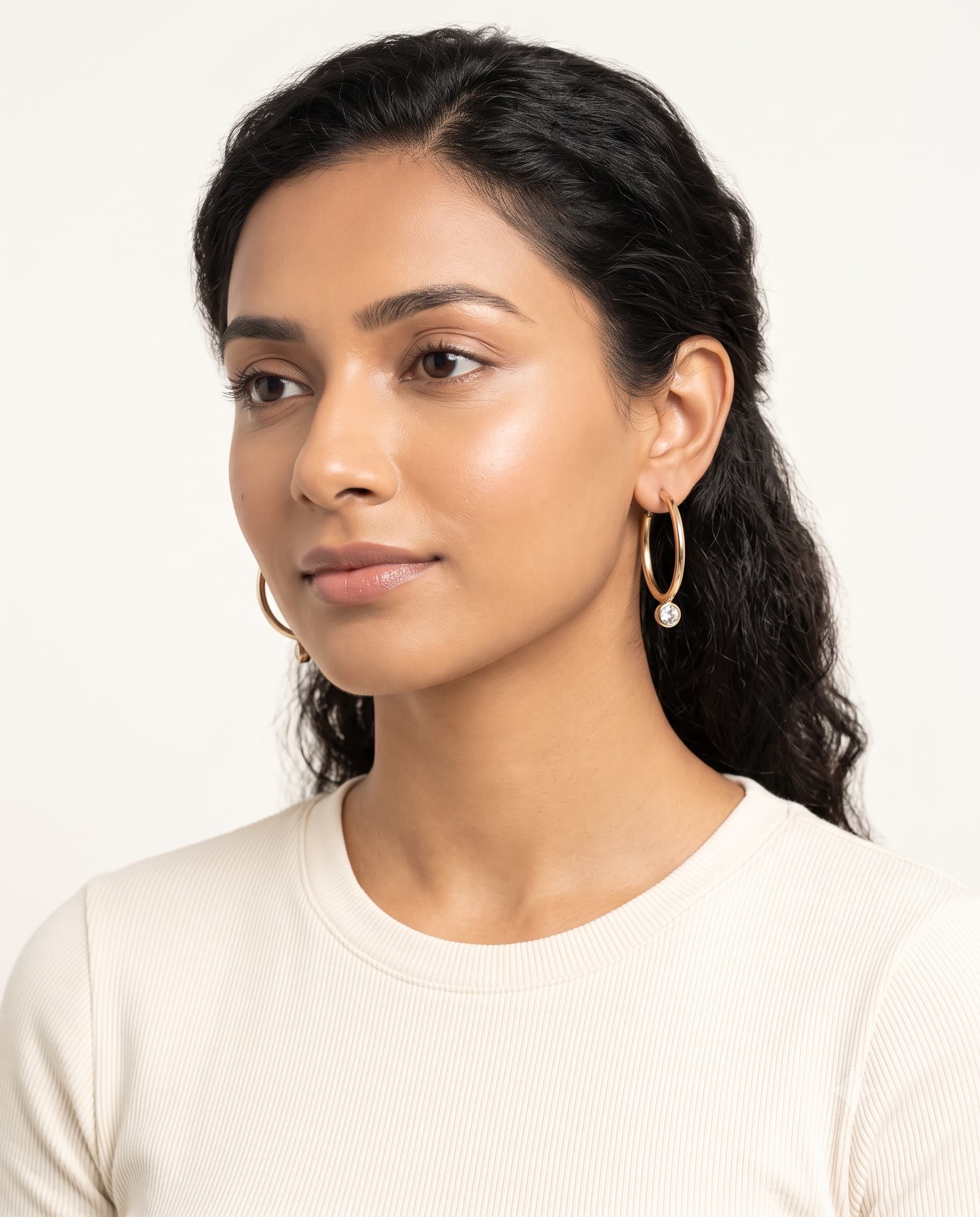 Model wearing solitaire hoop earrings