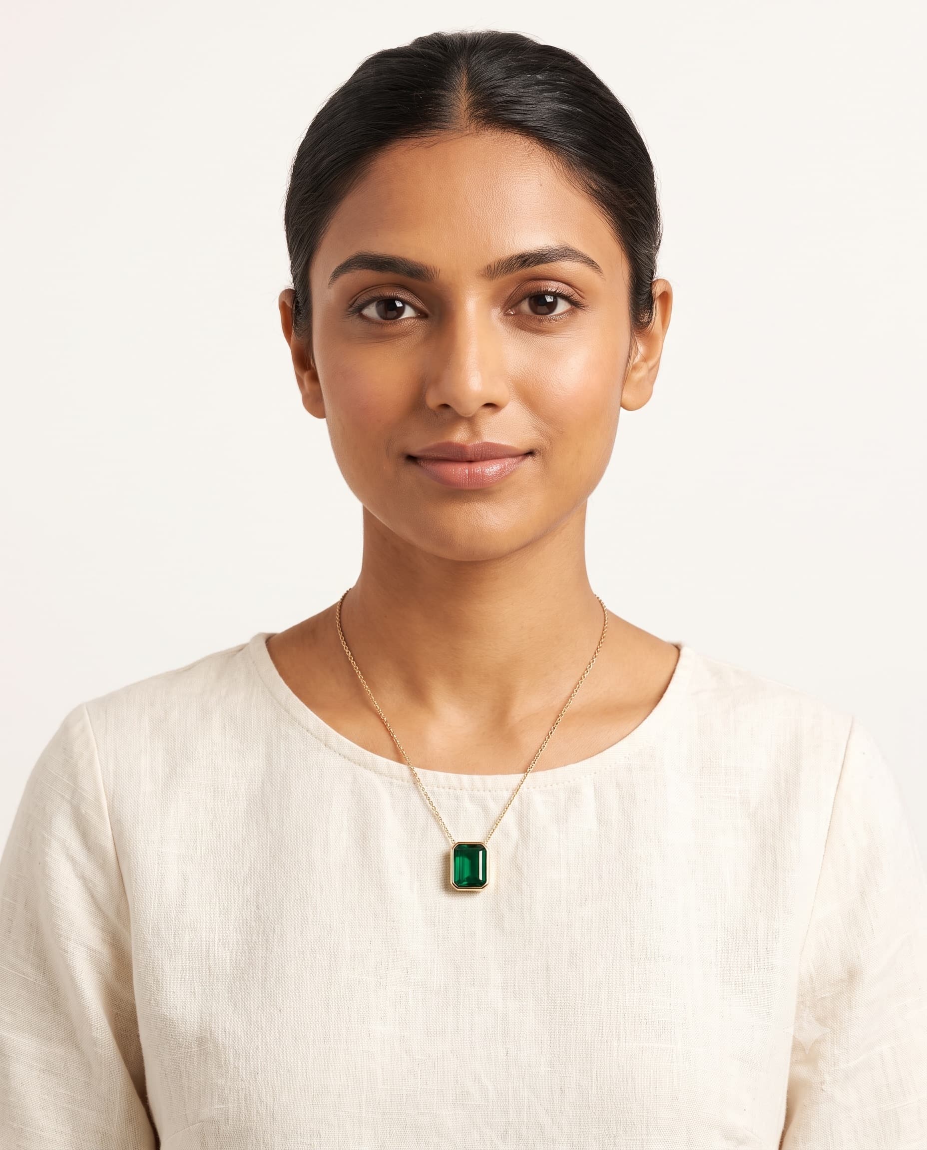 Model wearing an emerald pendant necklace