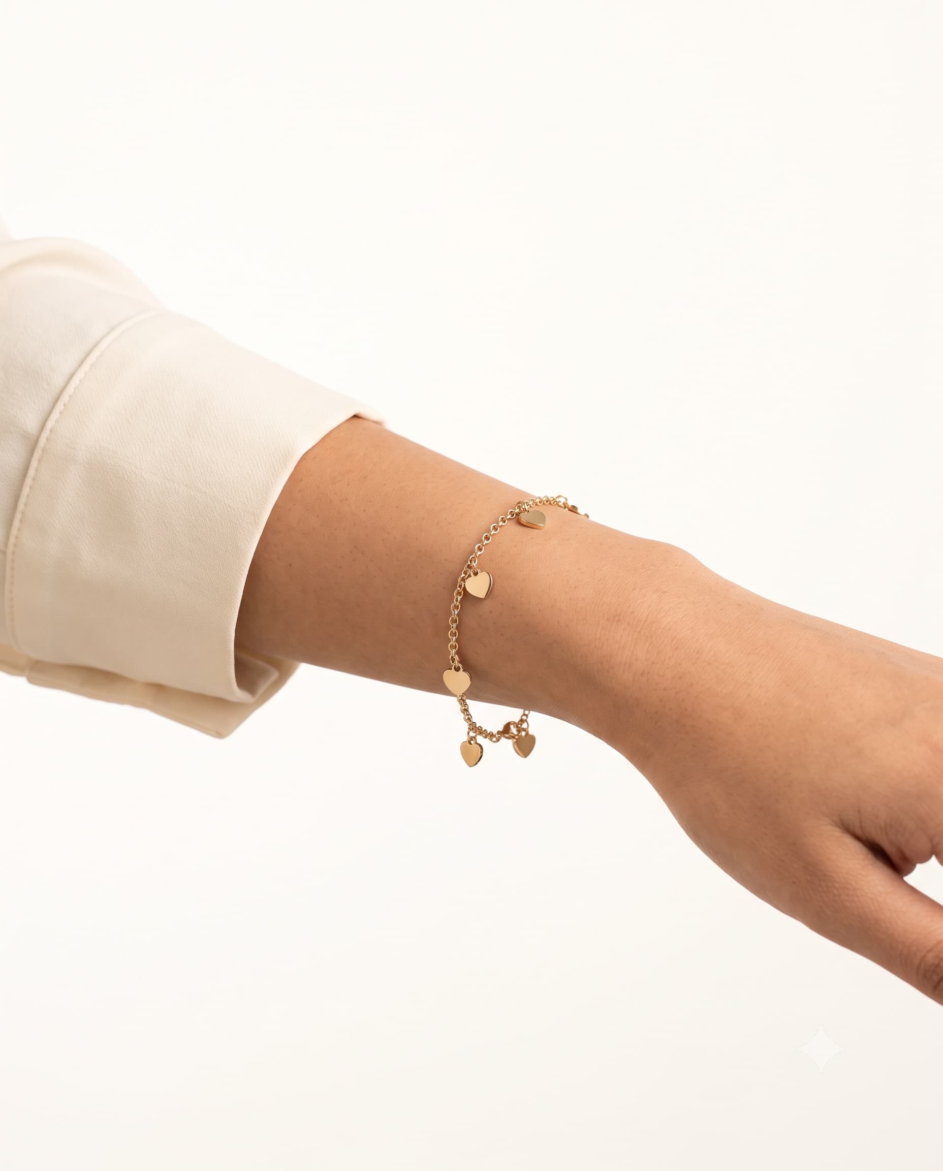 Model wearing a hearts charm bracelet