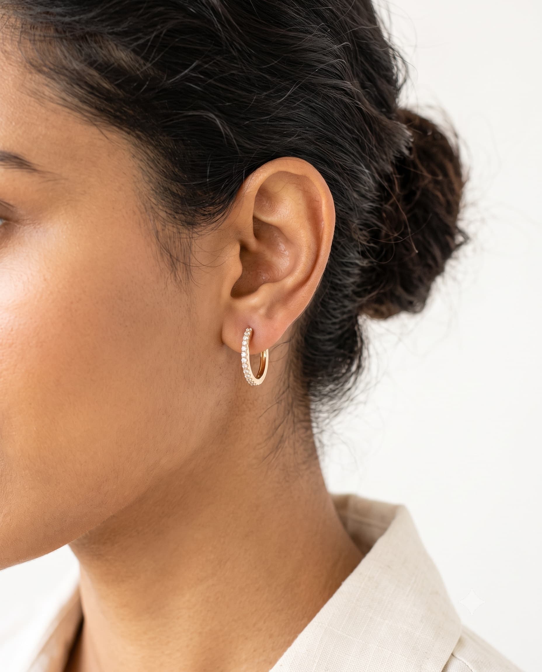 Model wearing diamond huggie hoop earrings